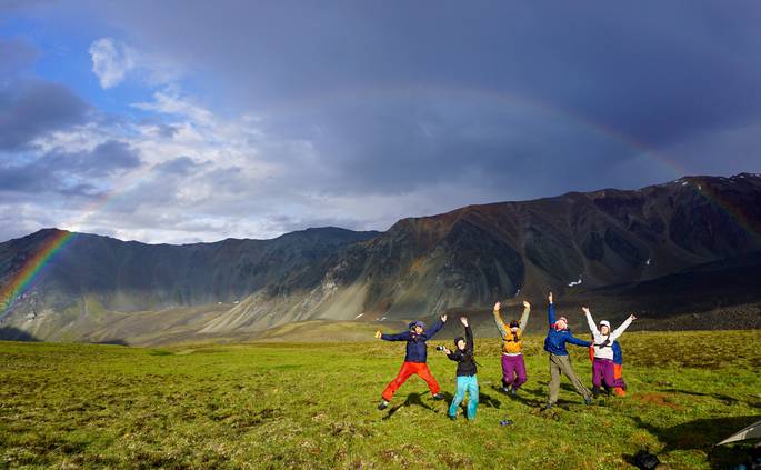 catherine-rocchi-ak-24.jpg__685x423_q70_crop_subject_location-3144,2679_subsampling-2 A group of students jumps in front of a rainbow in Alaska.