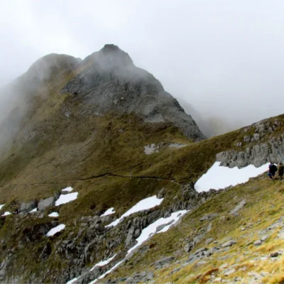 Students hiking through high misty peaks in New Zealand.