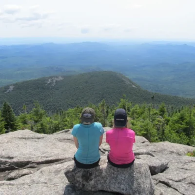 Two girls stop for a break while backpacking in the Adirondacks.