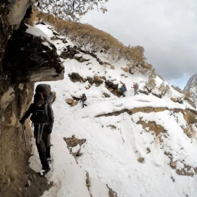 Students traversing a weathered mountain section in a mountainous range in India.