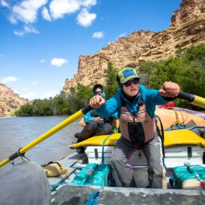 Student rowing a pack raft in the Rocky Mountains.