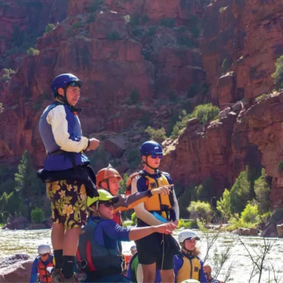 Students discussing route planning strategies for the whitewater ahead.