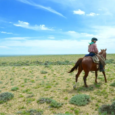 Horse packing student rides across a stretch of Wyoming's Red Desert.