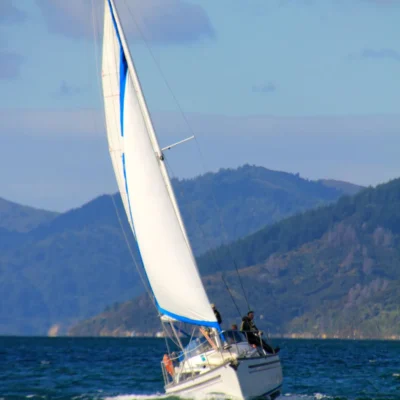 Students sailing a keelboat off the shores of New Zealand's South Island.