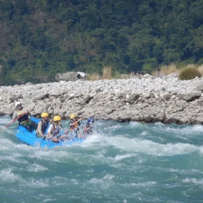 Some students navigating through fast-paced whitewater on a raft.