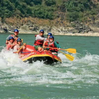 Students have fun in the rapids while whitewater rafting in India.