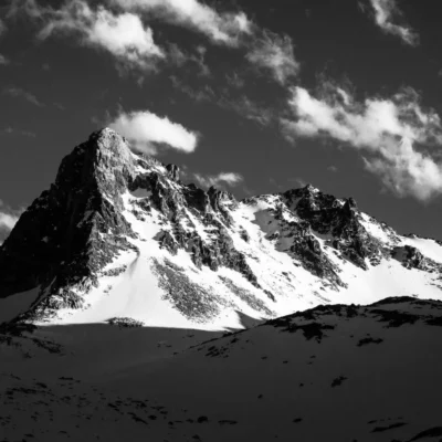 View from below of a rocky mountaintop.