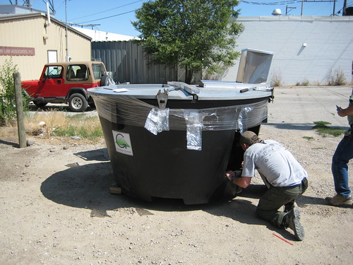Latane inspects the inside of the composter.