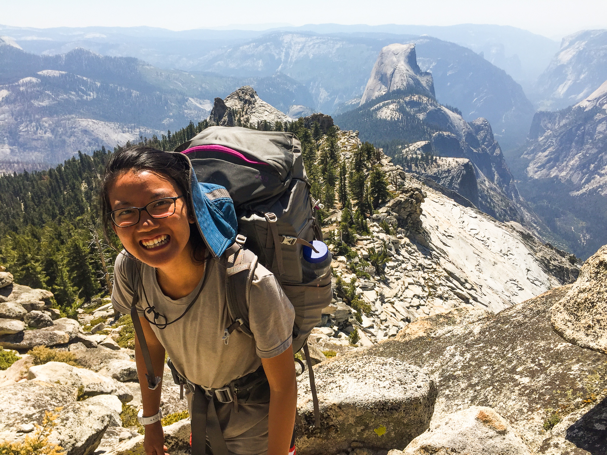 Kristen Lee smiles up at her classmate as they summit a peak.