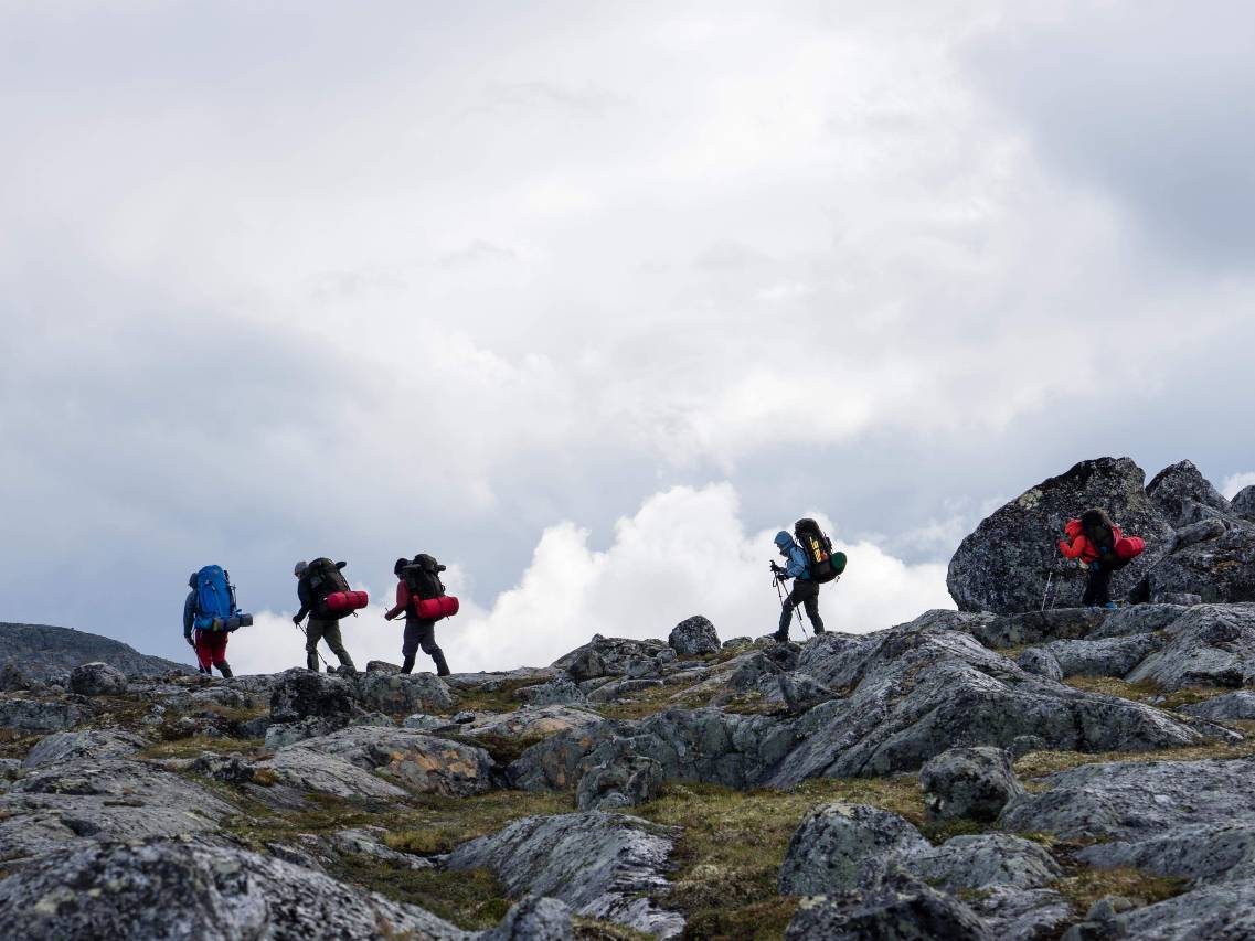 Backpackers cross a mountain ridge