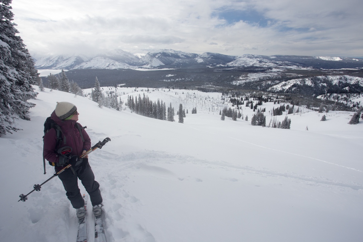 Woman pausing to rest while backcountry ski touring