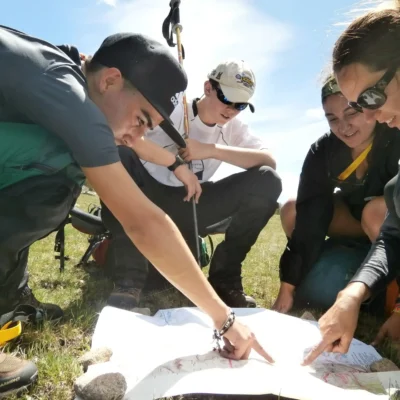 Students work with an instructor to determine their location on a map. Credit: Amit Arora