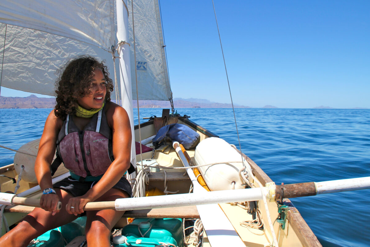 Semester student Tiffany takes to the oars on a NOLS Mexico Sailing course.