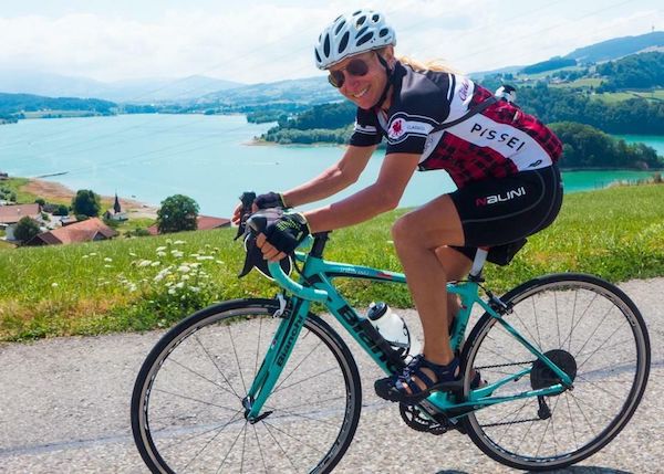 smiling cyclist rides road bike in Europe on Ciclismo Classico trip
