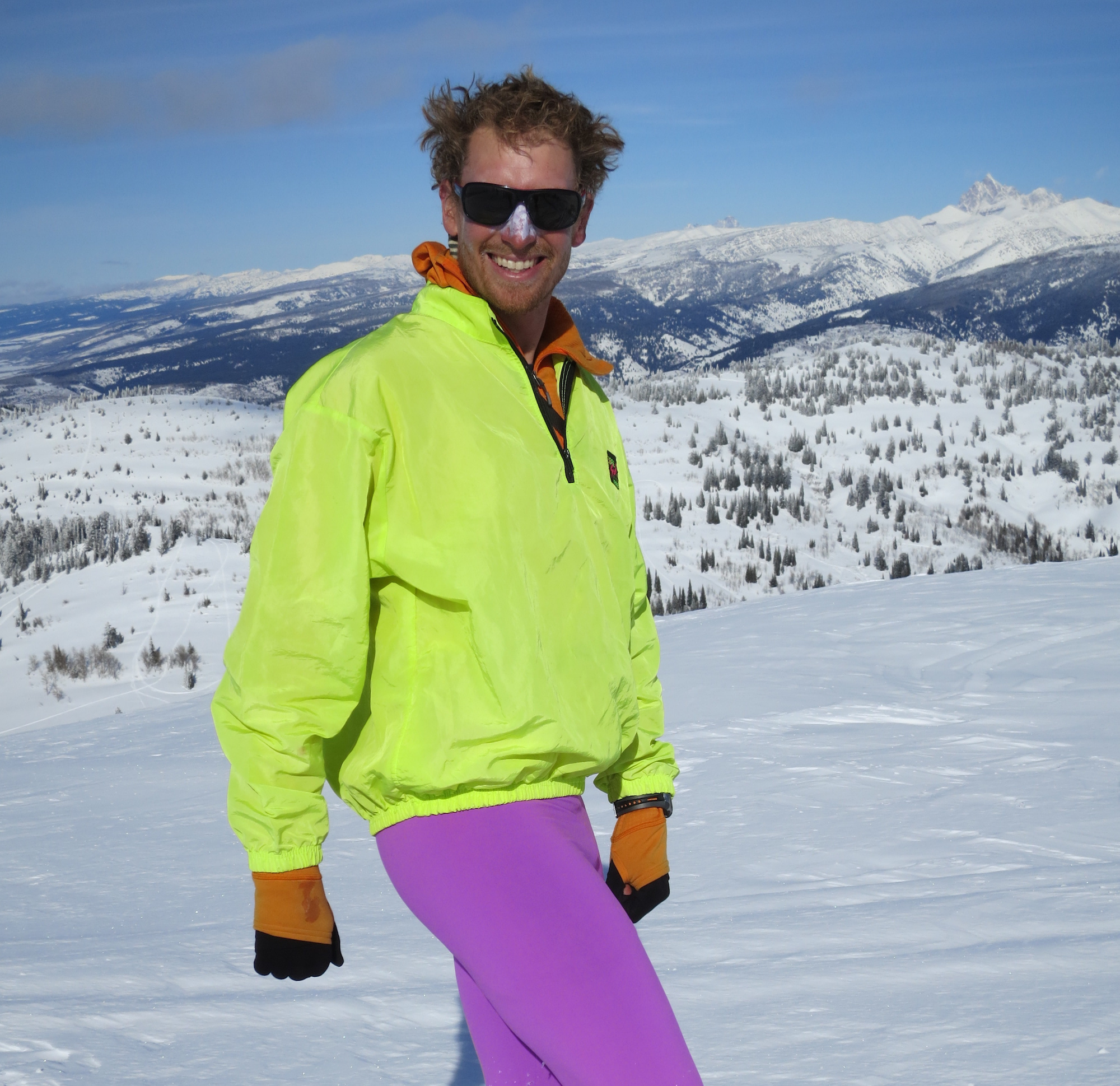 NOLS participant with fluorescent jacket and brightly colored tights models winter fashion