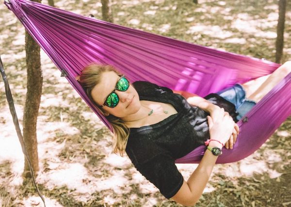 Kammok CEO and NOLS grad Haley Robison smiles for the camera in hammock