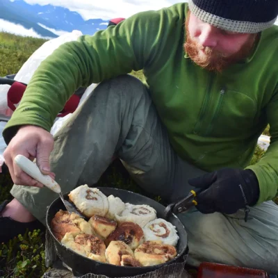 A student flipping some buttery, crispy, chewy cinnamon rolls on the last morning of backpacking in the Chugach Range. Credit: Sabrina Stein