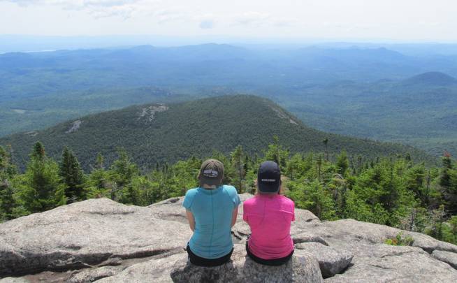 Two girls stop for a break while backbacking in the Adirondacks