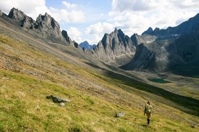 ashley_wise_yk_023.jpg__655x5000_q70_subject_location-2814,1925_subsampling-2 A student hikes into a sweeping valley ringed with jagged peaks while backpacking in the Yukon.