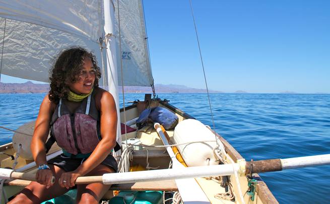 A student uses oars while out on a sailboat in Baja California, Mexico.