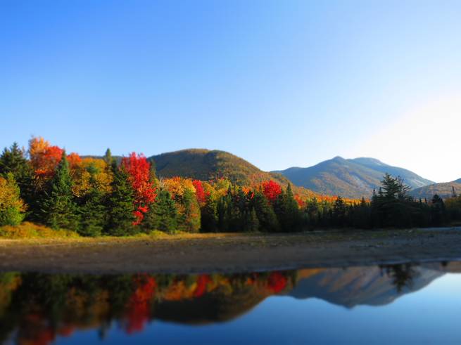 lindsay-yost-ne-36_1.jpg__655x5000_q70_subject_location-2000,1505_subsampling-2 The vibrant colors of fall foliage are reflected in the glassy surface of a lake in the Adirondacks.