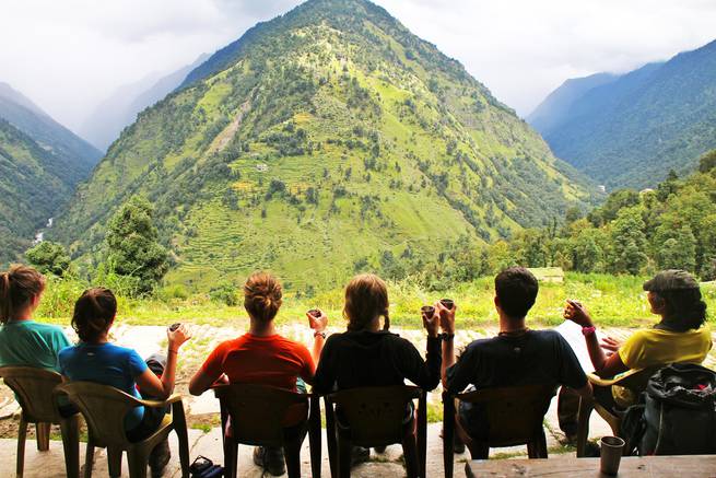 Students enjoy a chai stop along the trail while backpacking in India's Kumaon Himalaya.