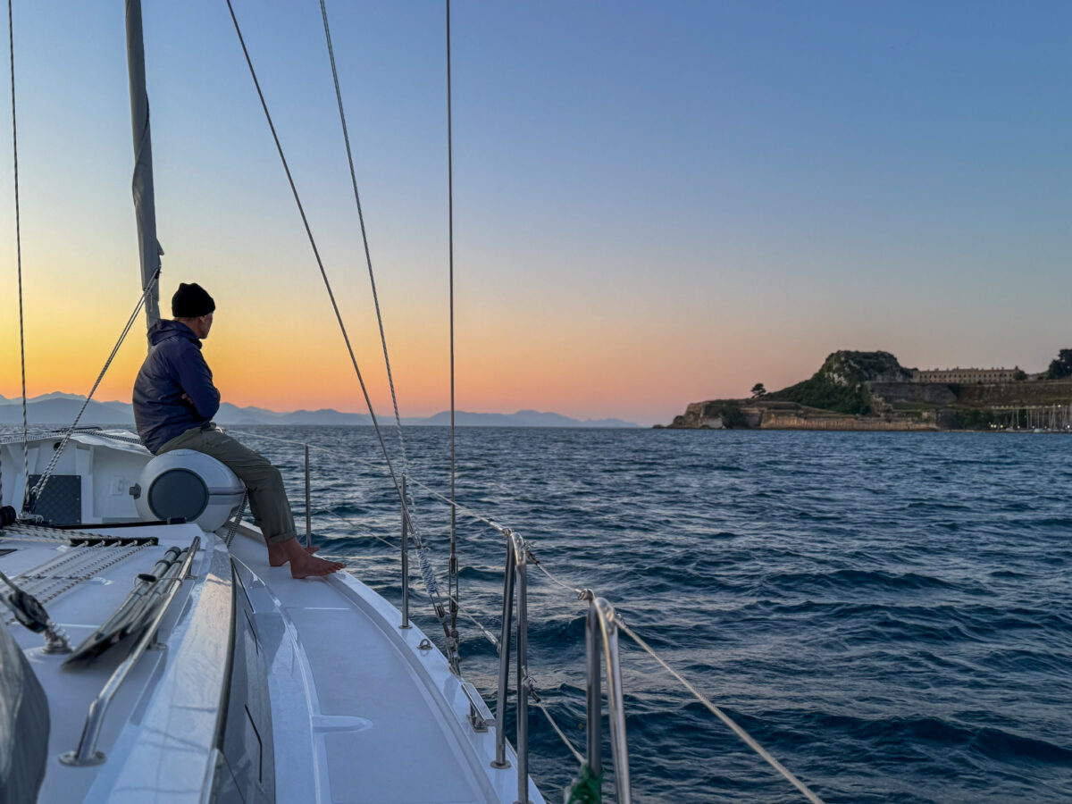 Sailing participant looking at the sunset from the deck.