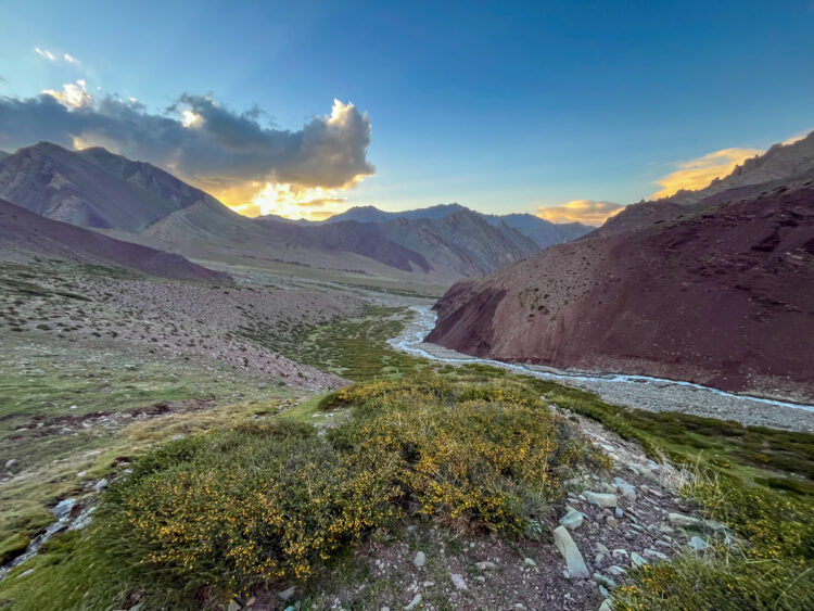 River flowing sunset mountains