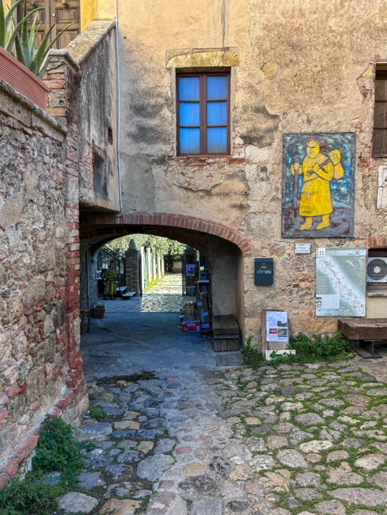 Stone walkway with a yellow painting of a historical hiker.