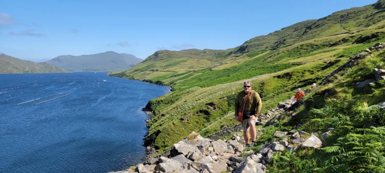 Hiker poses next to the sea